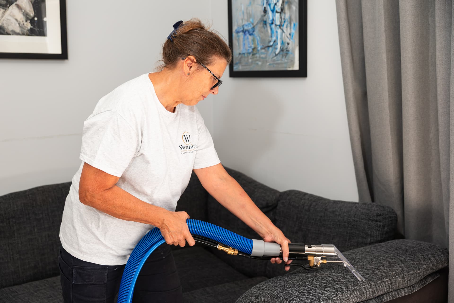 Cleaning a fabric sofa with an upholstery tool